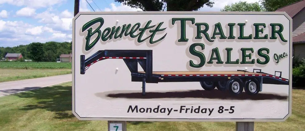 Bennett Trailer Sales road sign with hours listed.